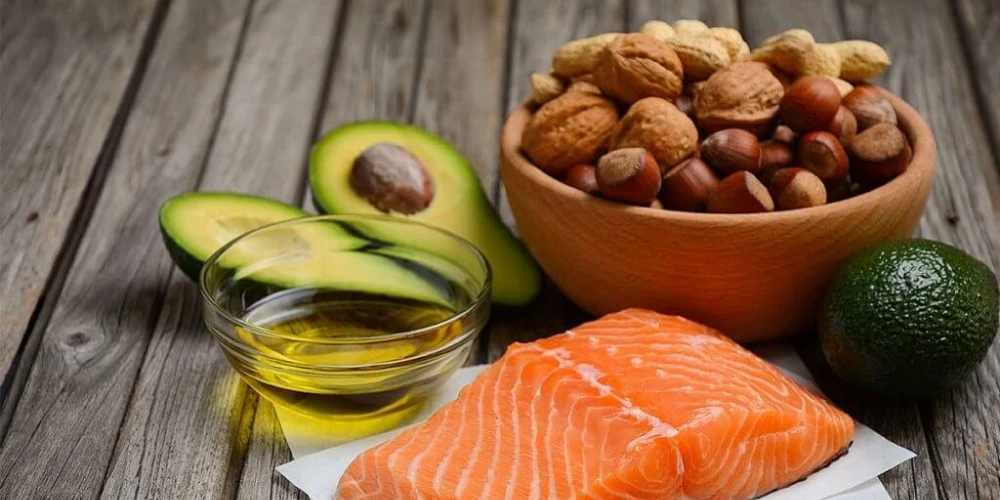 Salmon and avocado, two nutritious options that promote health, are displayed on a rustic wooden table.